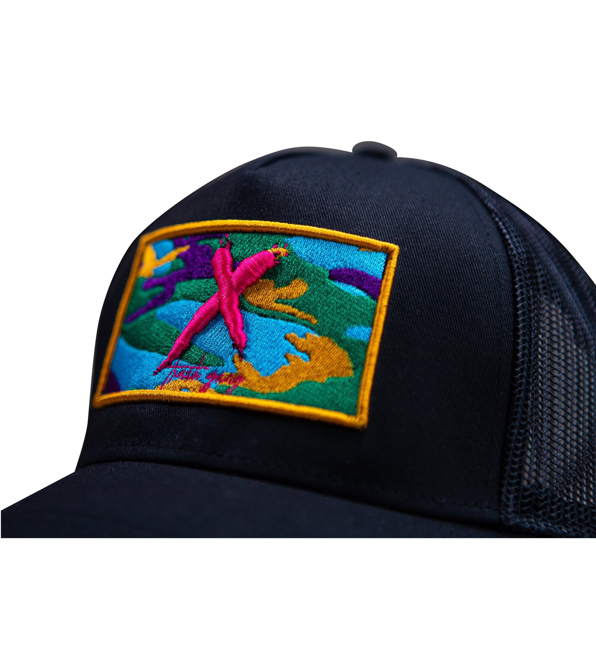 Close-up of 3D embroidery signature 'X' on Camo Mesh Snapback Hat