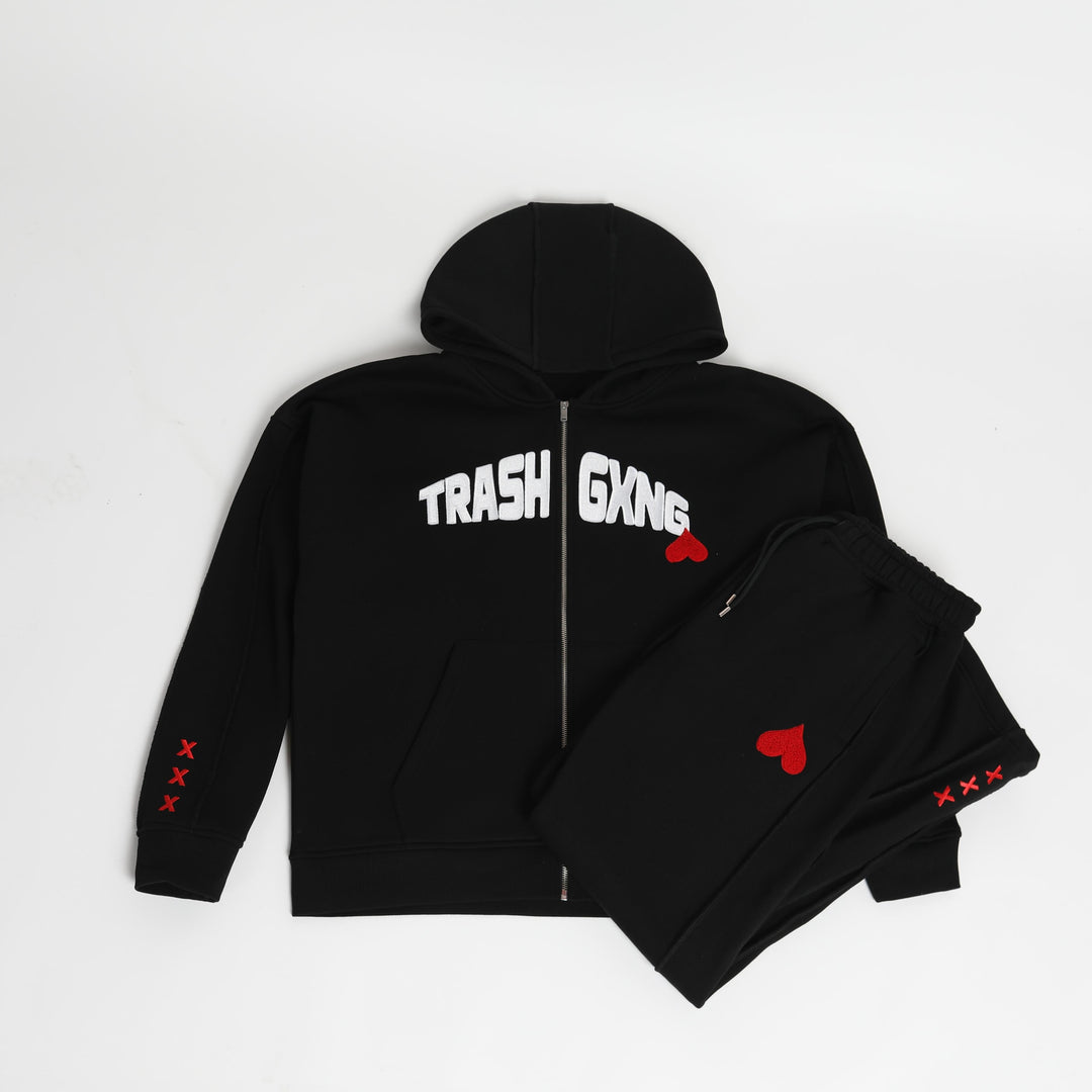 OG Love Black Tracksuit flat lay image with 'TRASH GXNG' text and red heart designs on a white background